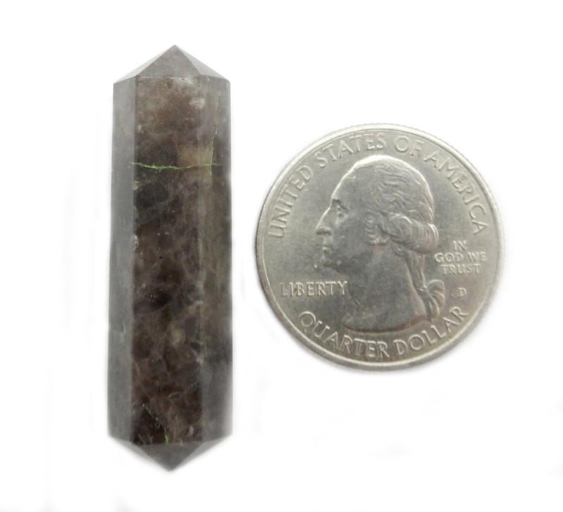 one smokey quartz double terminated pencil point on white background with quarter for size reference