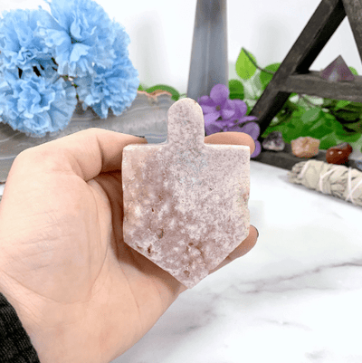 pink amethyst dreidel in hand for size reference 