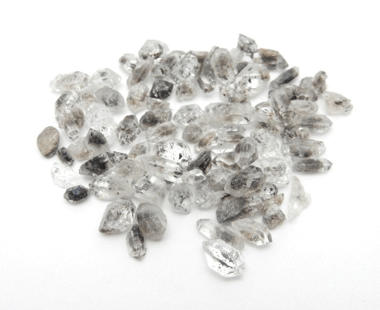 Tiny Tibetan Crystal Quartz Double Terminated Points Herkimer Style displayed in white background showing variation in gemstone