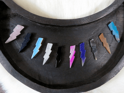 colorful agate lightning bolts displayed in black moon tray