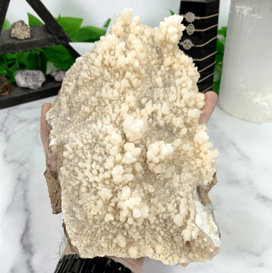 calcite cluster in hand for size reference 