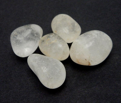 Close Up of 5 Drilled Tumbled Stone Crystal Quartz Polished Bead