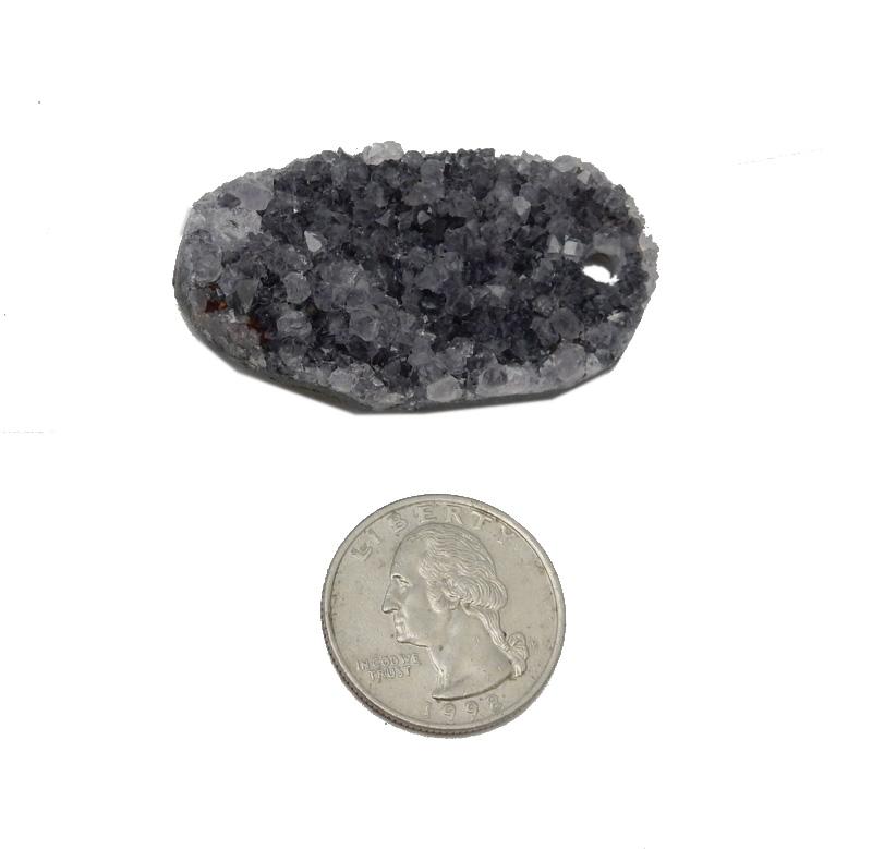 Oval druzy on a white background with a comparison to a quarter.  It is larger than the quarter.