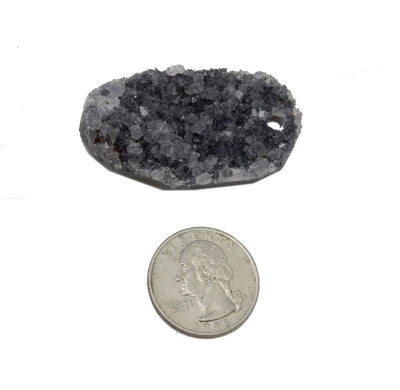 Oval druzy on a white background with a comparison to a quarter.  It is larger than the quarter.