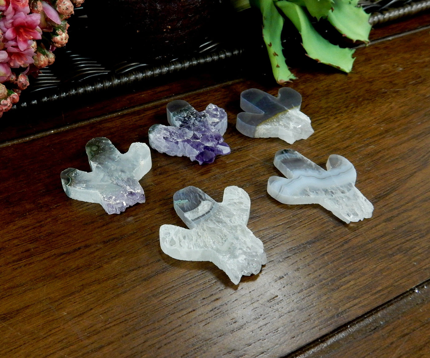 angled shot of amethyst cactus cabochons with decorations in the background