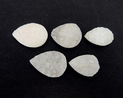 multiple Large White Teardrop Druzy Beads displayed to show various sizes natural formations inclusions and shades of white