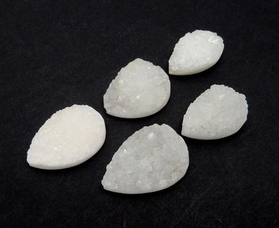 side view of multiple Large White Teardrop Druzy Beads for thickness reference