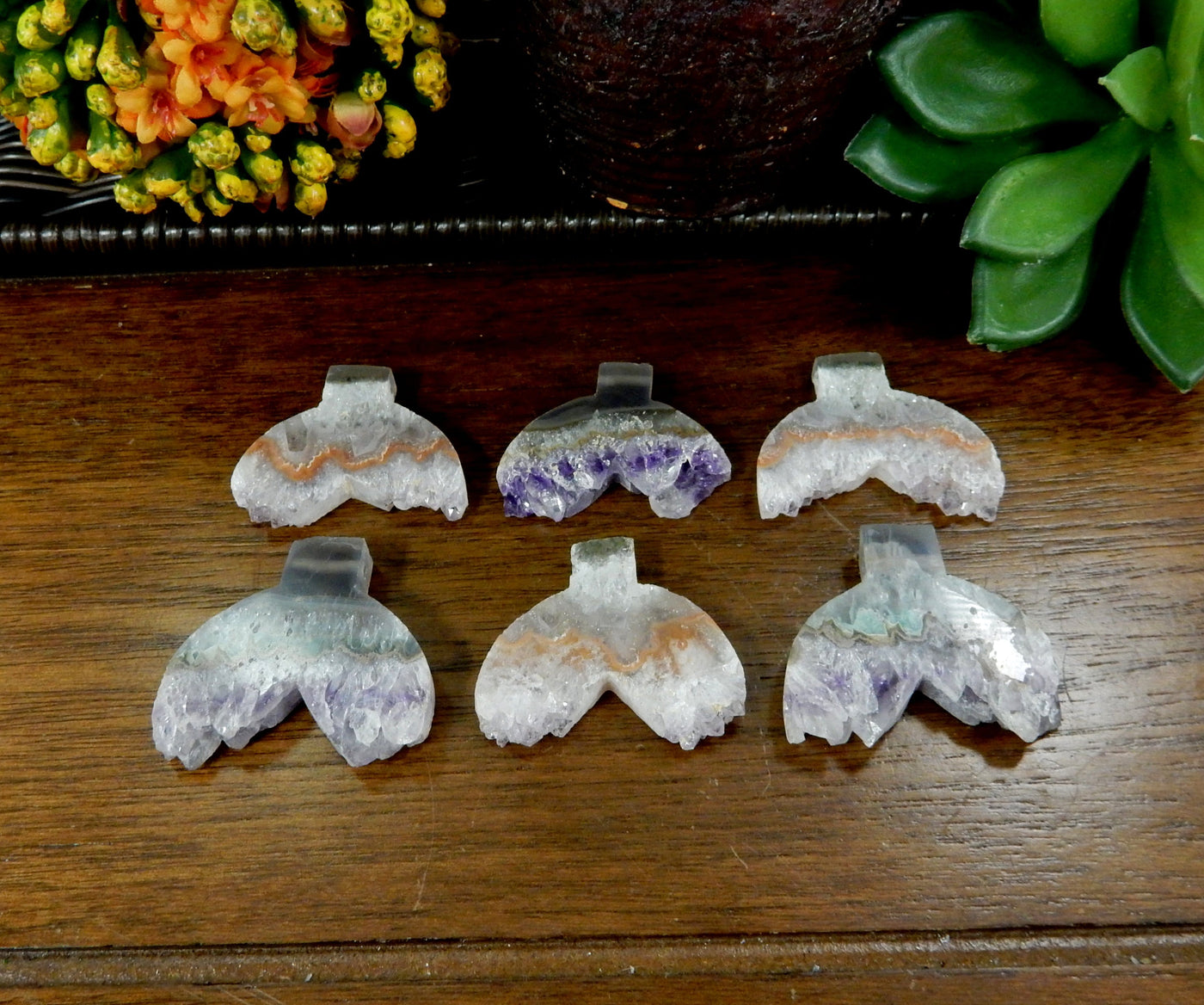 multiple amethyst shaped mermaid tails displayed to show the differences in the color shades 