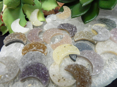 up close shot of Druzy Moon Cabochons with decorations in the background