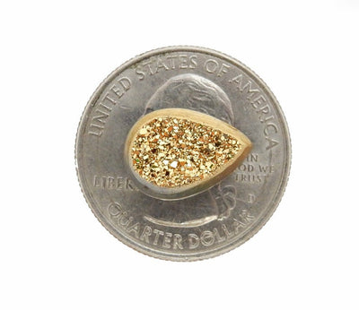gold colored titanium teardrop druzy cabochon on quarter for size reference
