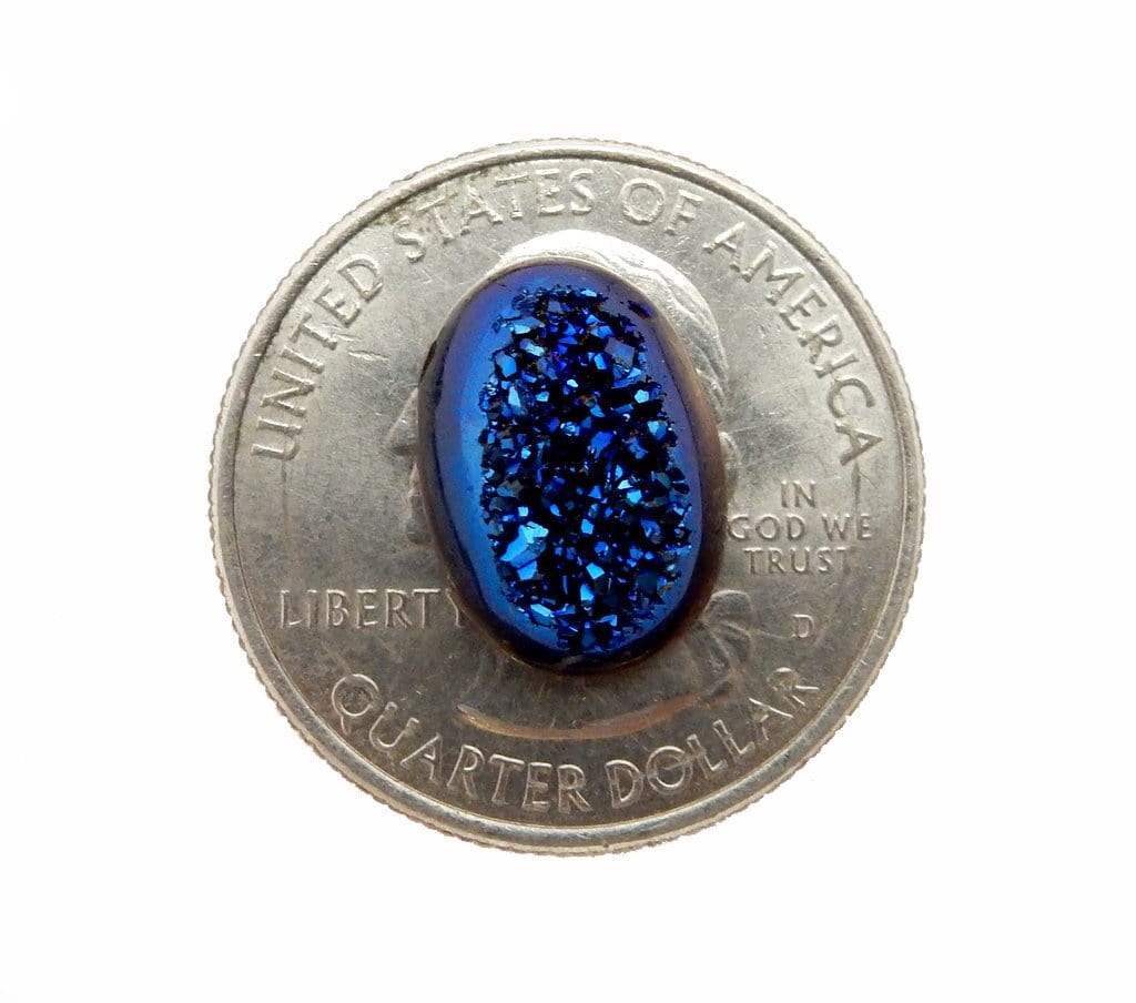 Mystic Blue Colored Titanium Oval Shaped Druzy Cabochon--Close up view of stone on top of quarter compared for size reference. 