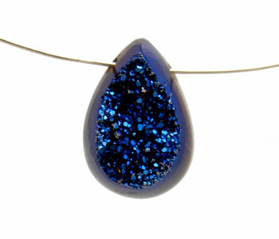 blue tear dropped druzy cabochon on wire on white background
