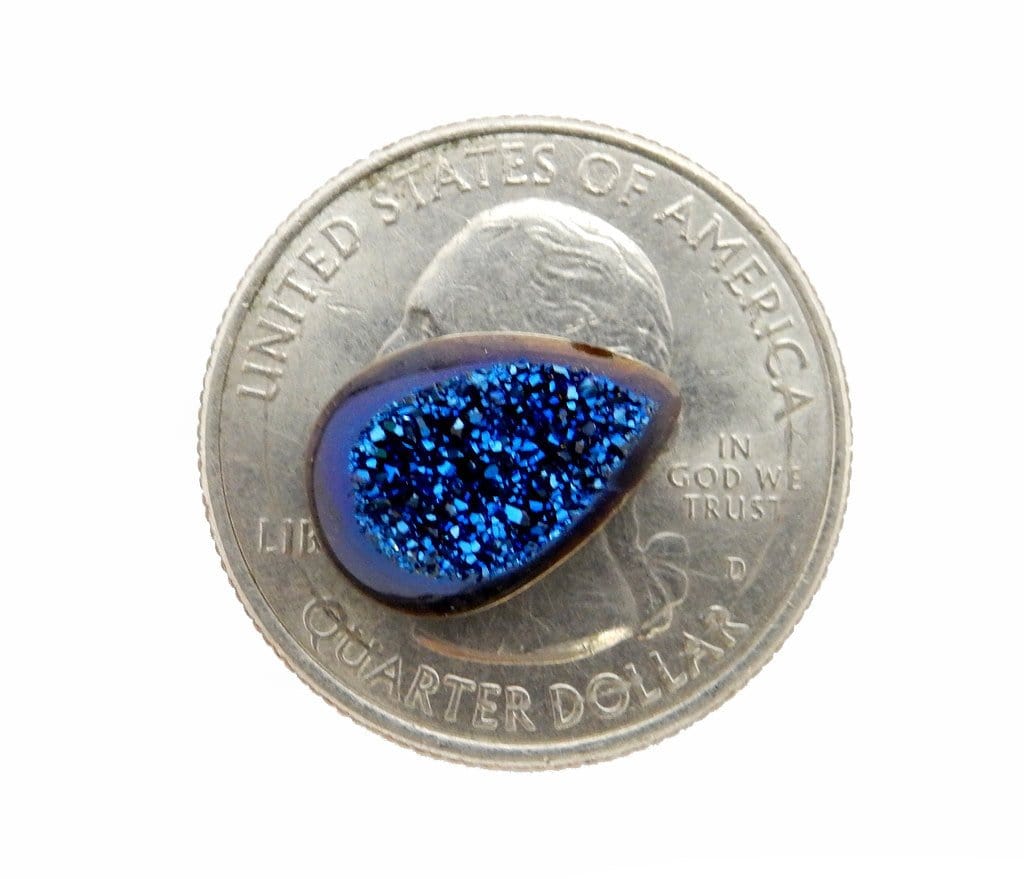 blue titanium teardrop shaped druzy cabochon on quarter for size reference