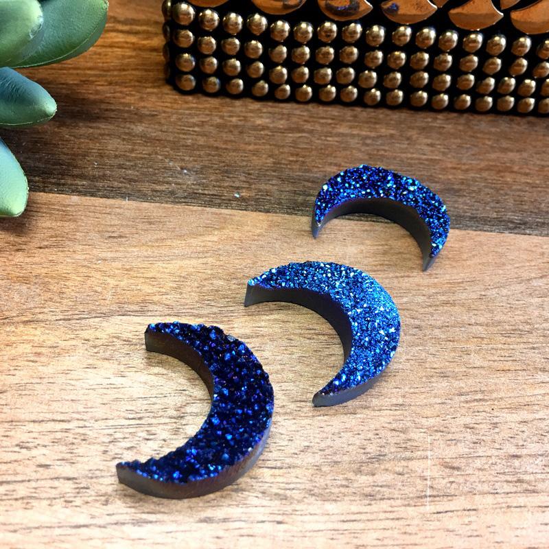 Druzy Crescent - 3 blue on a table