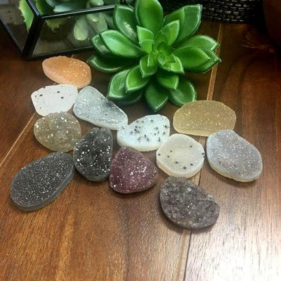 Assorted Drilled Freeform Druzy Medium Size on Wooden Background.