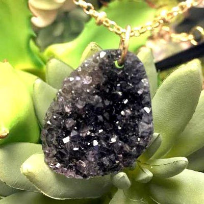 Black Drilled Freeform Druzy in Necklace on Succulents background. 