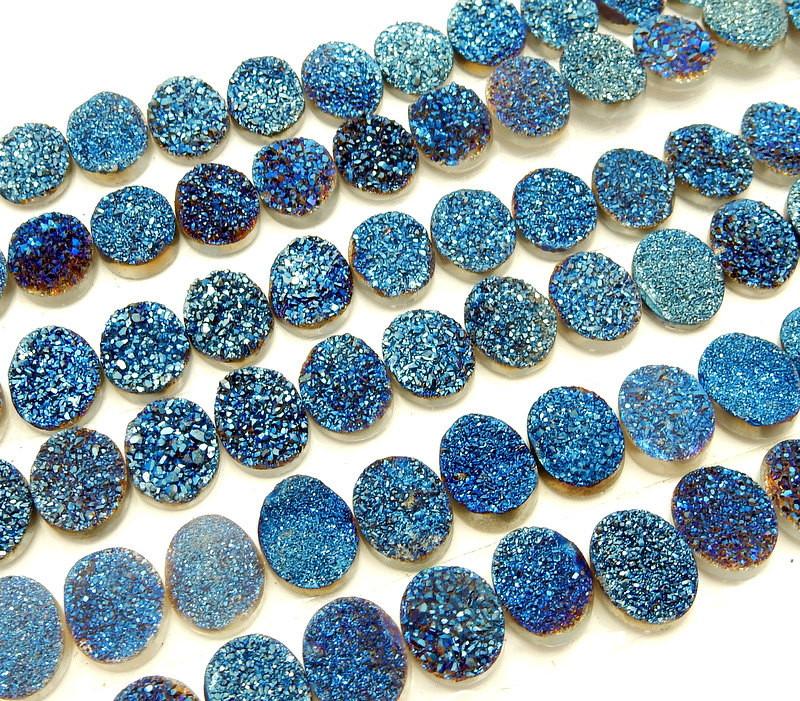 side view of multiple  Blue Oval Shaped Druzy Cabochons that measure  10mm x 8mm displayed for thickness reference