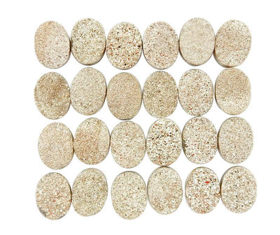 gold oval druzy cabochons on white background