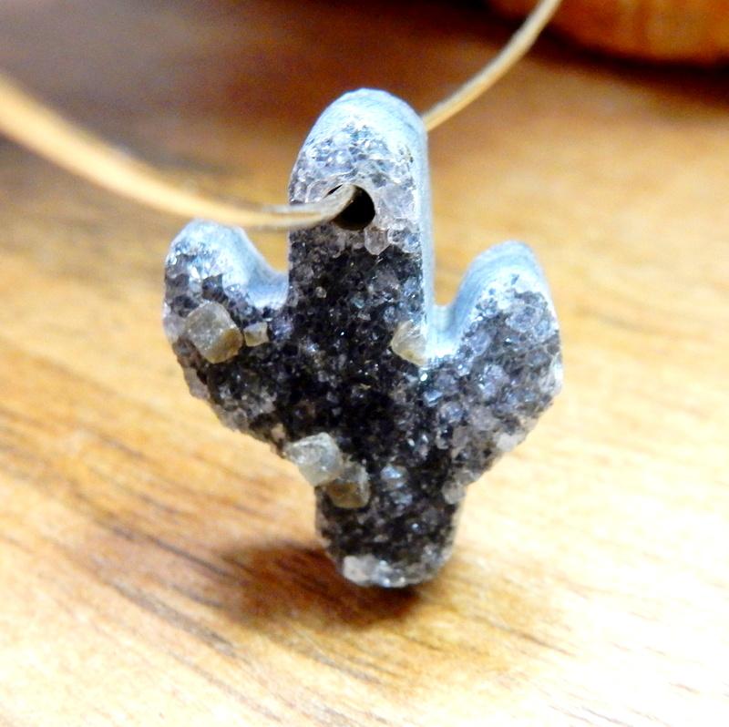 One quartz druzy cut into a cactus shape with a drilled hole on top threaded through a silver wire.