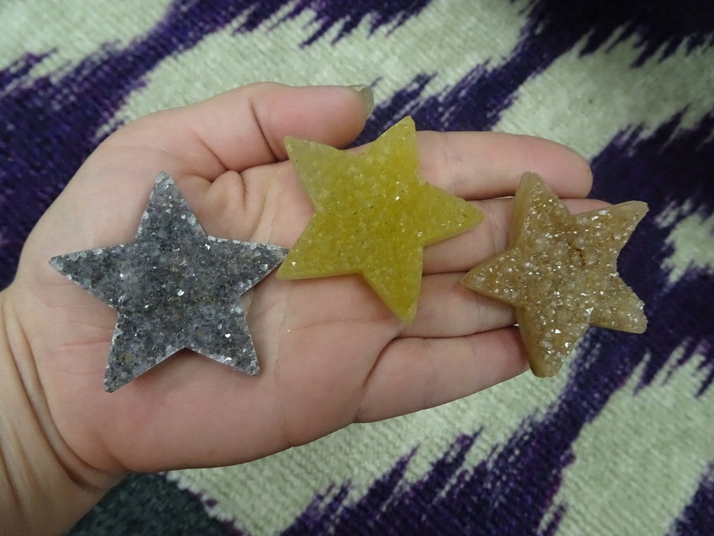 3 druzy stars in a hand