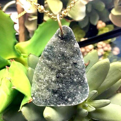  large freeform druzy with a gold wire through it to display as a necklace
