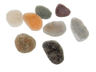 multiple large freeform druzies come in different colors such as white light grey gray dark gray orange purple brown with natural inclusions in a few