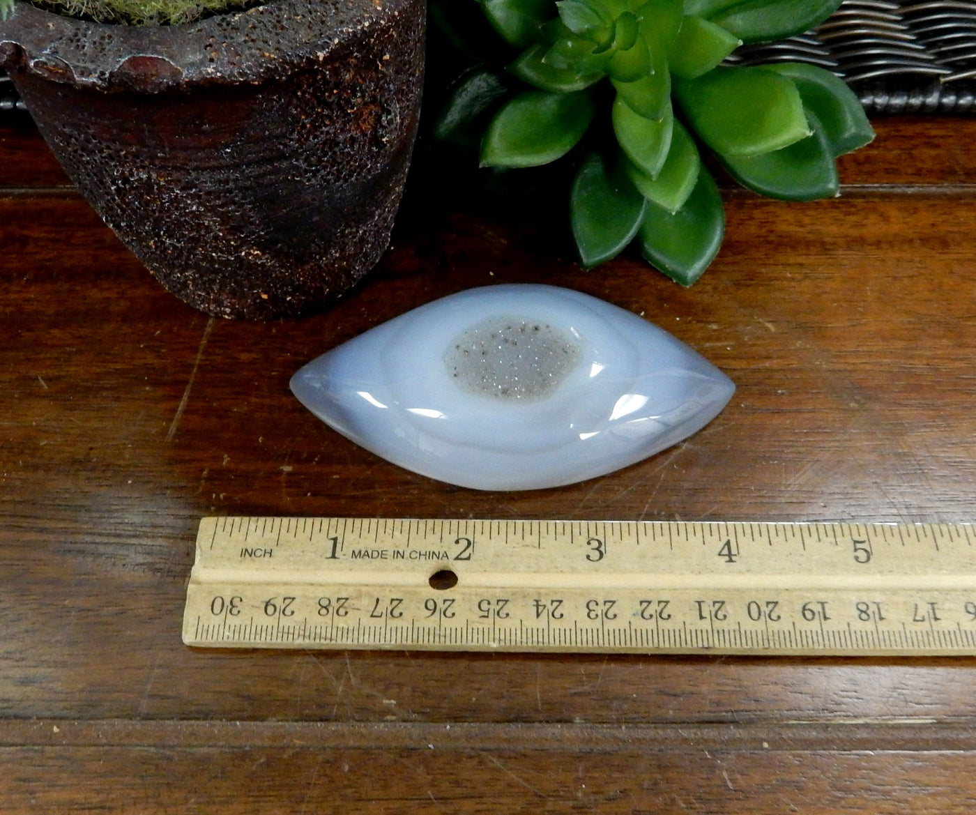 Marquise Druzy Agate Cabochon next to a ruler for size reference 