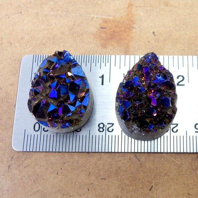Mystic Blue Titanium Druzy Teardrop Cabochons displayed on on ruler for size reference