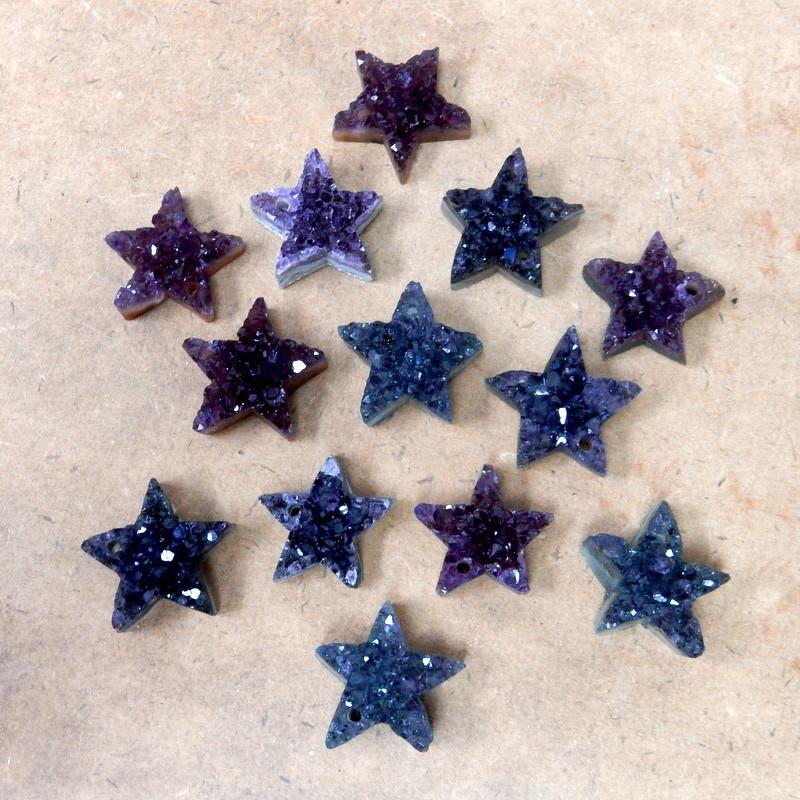 star druzy pendants on a table