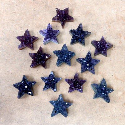 star druzy pendants on a table
