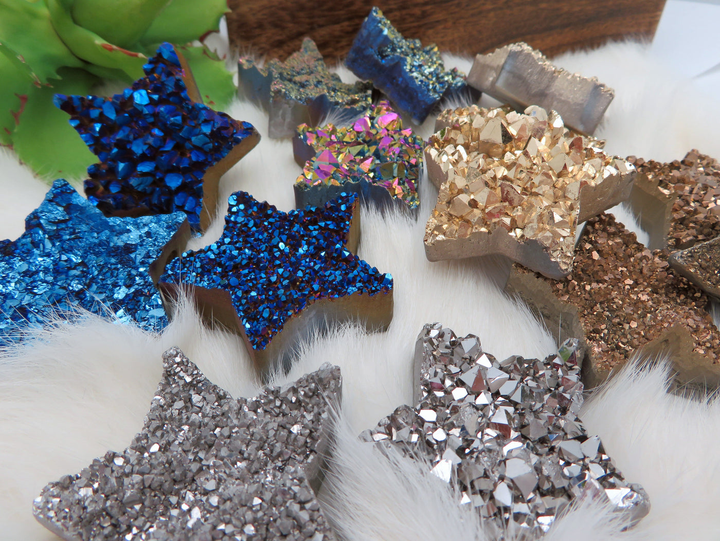Up close view of Titanium Treated Druzy Stars displayed on fuzzy white surface.