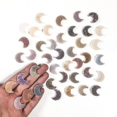 Various Druzy Moon Crescent cabochons in hand for size and characteristic  reference