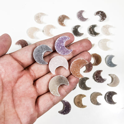 Various Druzy Moon Crescent cabochons in hand for characteristic reference