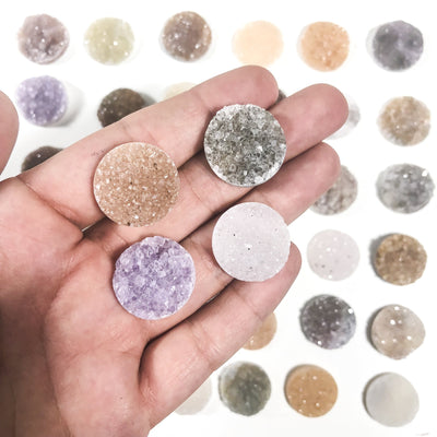 Various Druzy cicrle cabochons in hand for size and characteristic reference