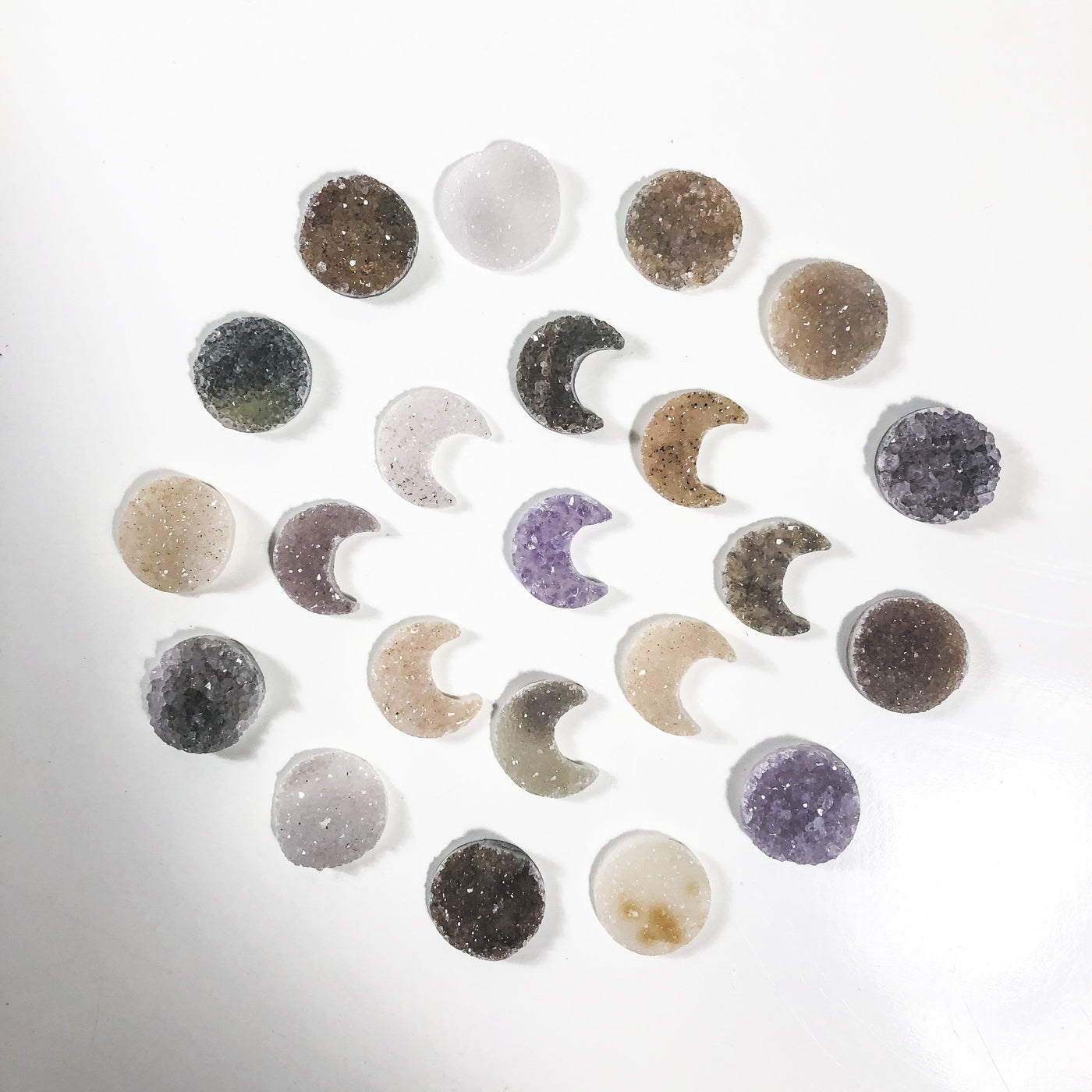 multiple Druzy Moon Crescent and Circle Cabochons displayed to show various colors and characteristics