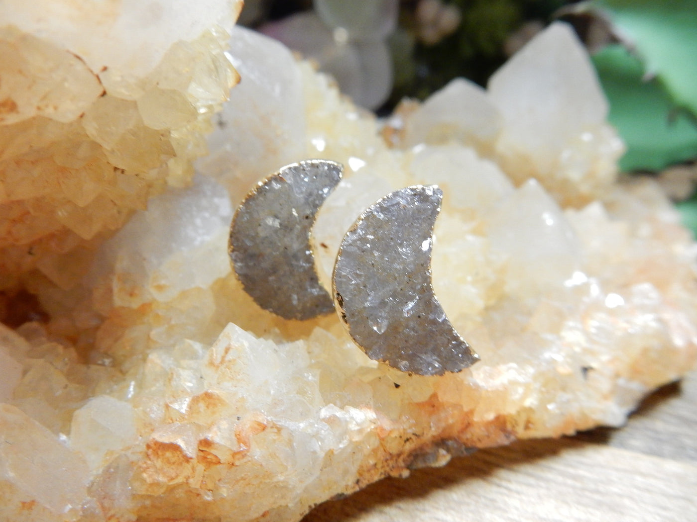 close up of moon shaped druzy earrings 