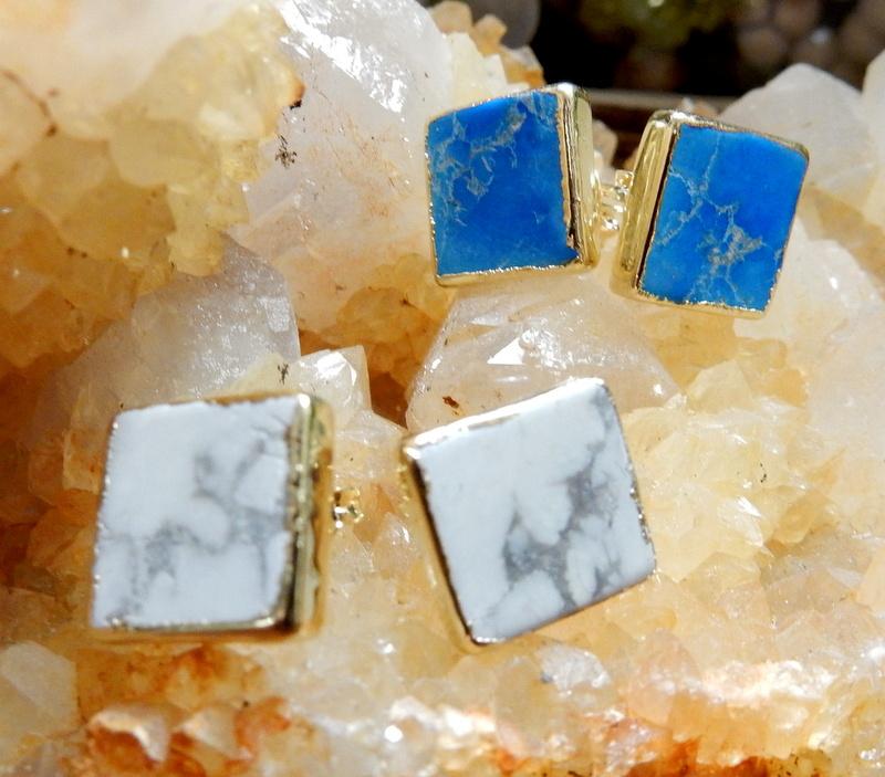 2 Gemstone Square Shaped Stud Earrings in White Howlite  and Turquoise Howlite on top of a citrine cluster 
