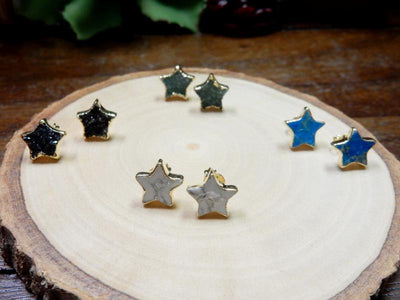 multiple star gemstone earrings displayed to show the differences in the gemstone types 