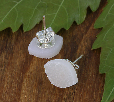 one pair of earrings on a table - white