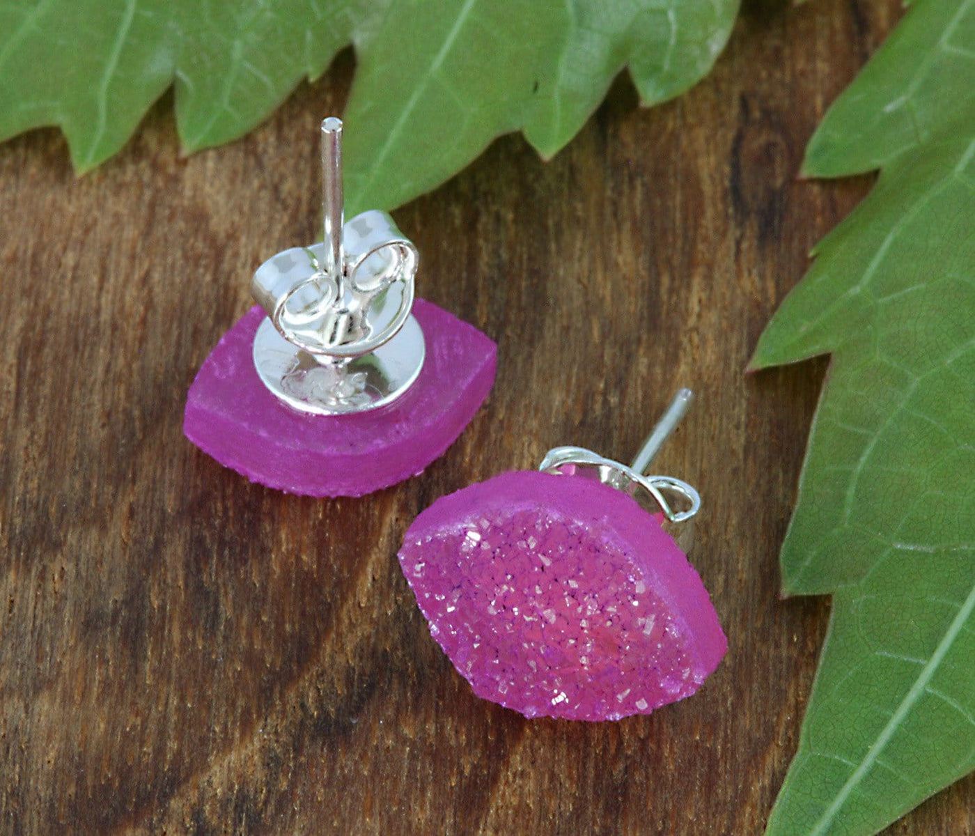 one pair of earrings on a table - pink