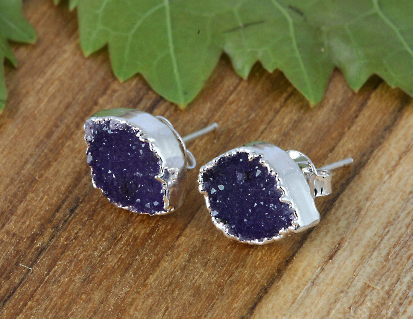 one pair of marquise earrings on a table  - purple