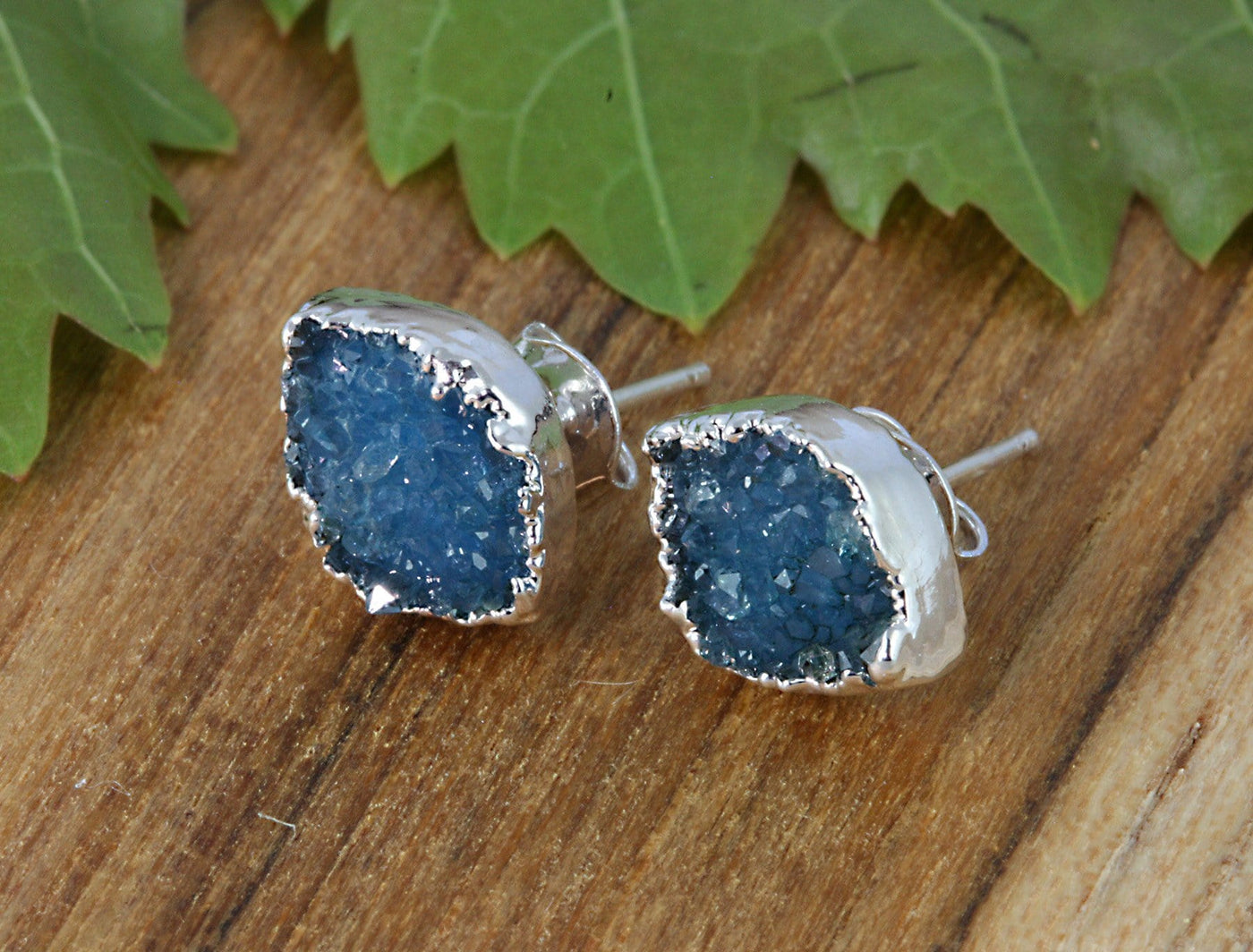 blue druzy earrings on a table