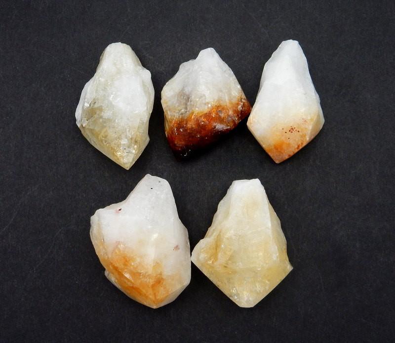 5 pieces of Extra Large Citrine Point on black background.