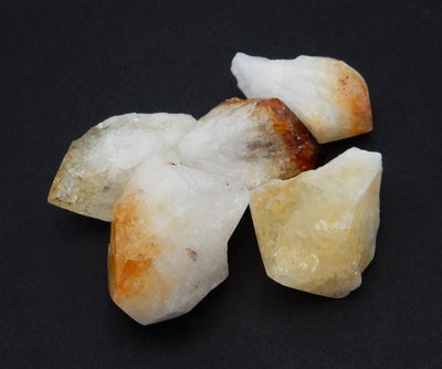 Extra Large Citrine Points next to each other on a black background.