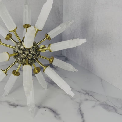 Video of Selenite Point Spike Globe with Pyrite Cluster Center on a marble surface.