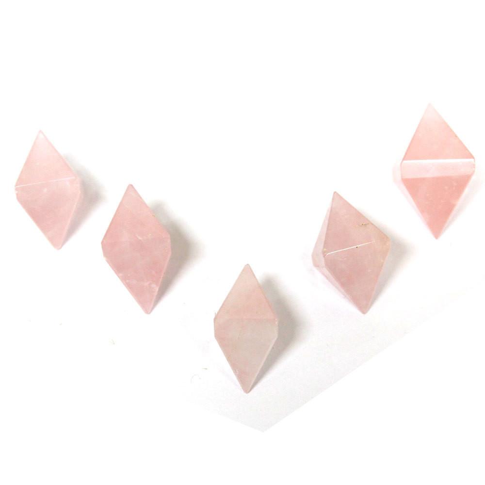 5 Rose Quartz Diamond Shaped Stones in V formation on white background