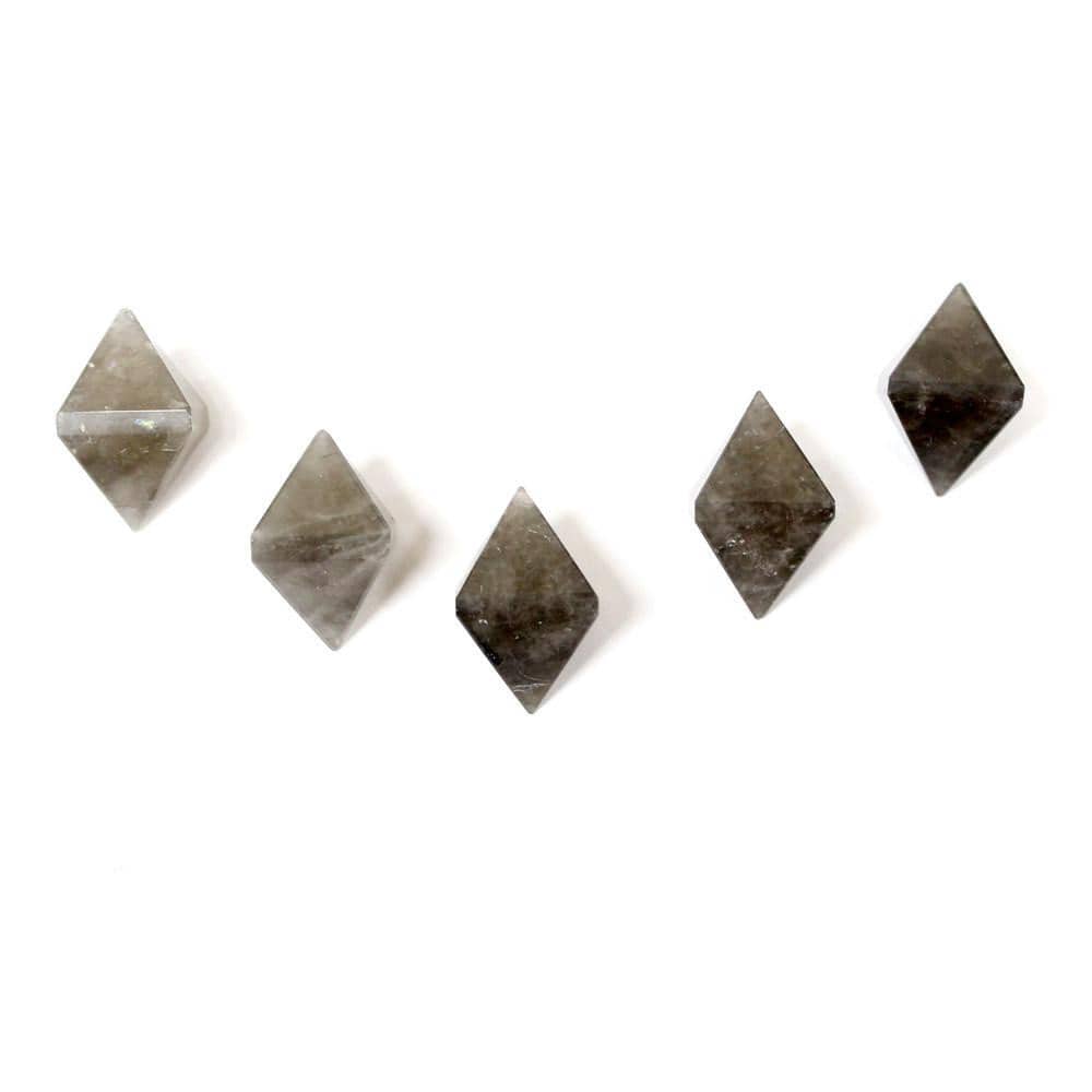 five smokey quartz diamond points on white background for possible variations