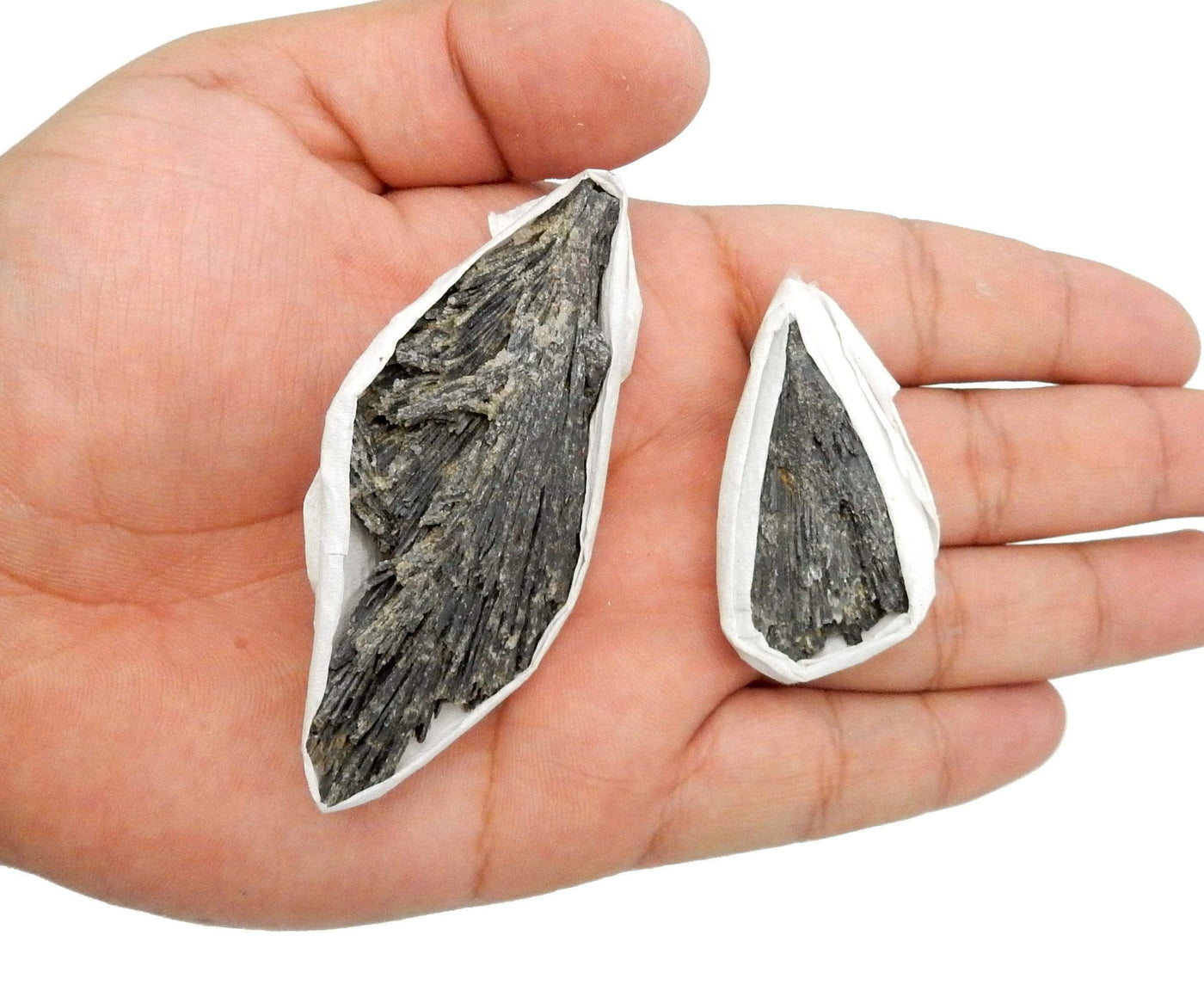 2 Black Kyanite Blades in a hand for size reference