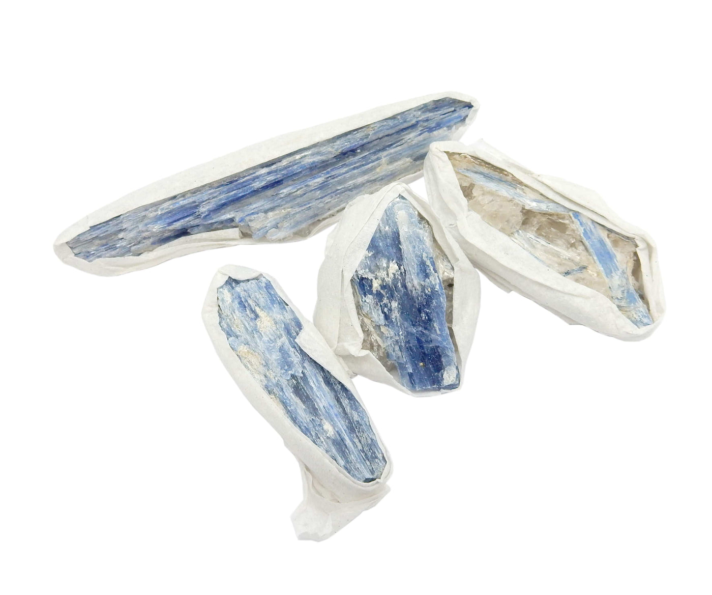 4 individual Blue Kyanite Blades displayed on a white surface, edges wrapped in tissue.