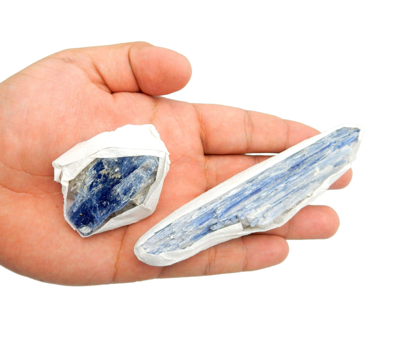 2 individual Blue Kyanite Blades displayed in hand, edges wrapped in tissue.